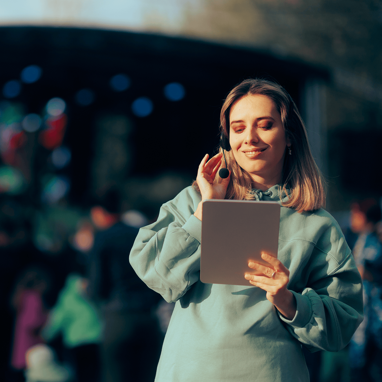 Event professional using a tablet, demonstrating dynamic scaling of high-bandwidth connectivity during peak seasonal demand.