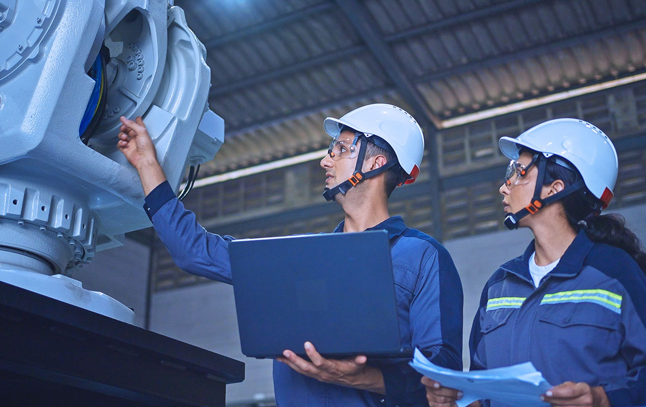 Employees in a manufacturing plant using IoT.