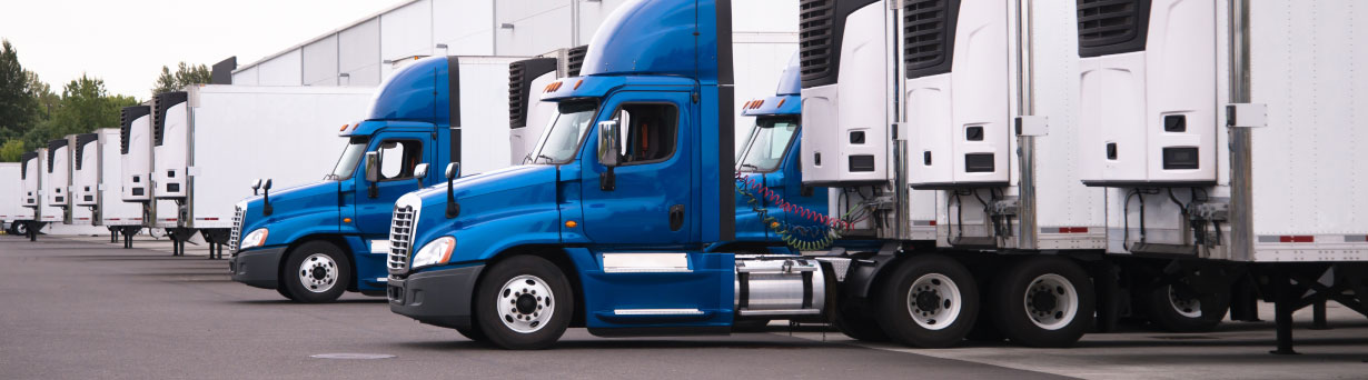 Fleet of trailers in a trailer bay equipped with trailer tracking and near real-time GPS and geo-fence alerts to improve inventory tracking.